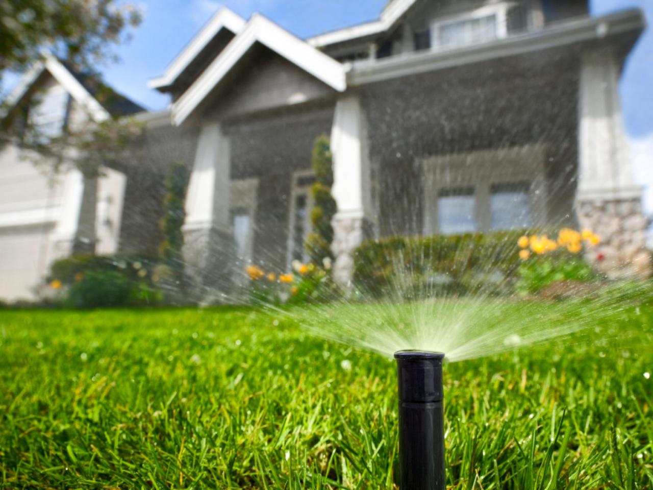 Sprinkler system watering a green lawn, Andover MN
